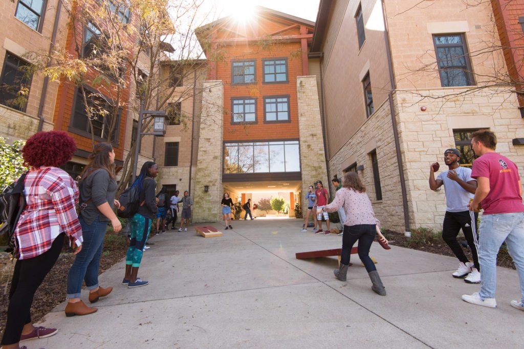 students walking towards campus building