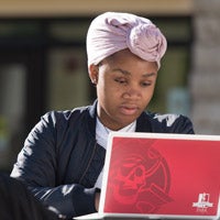 woman at laptop outside