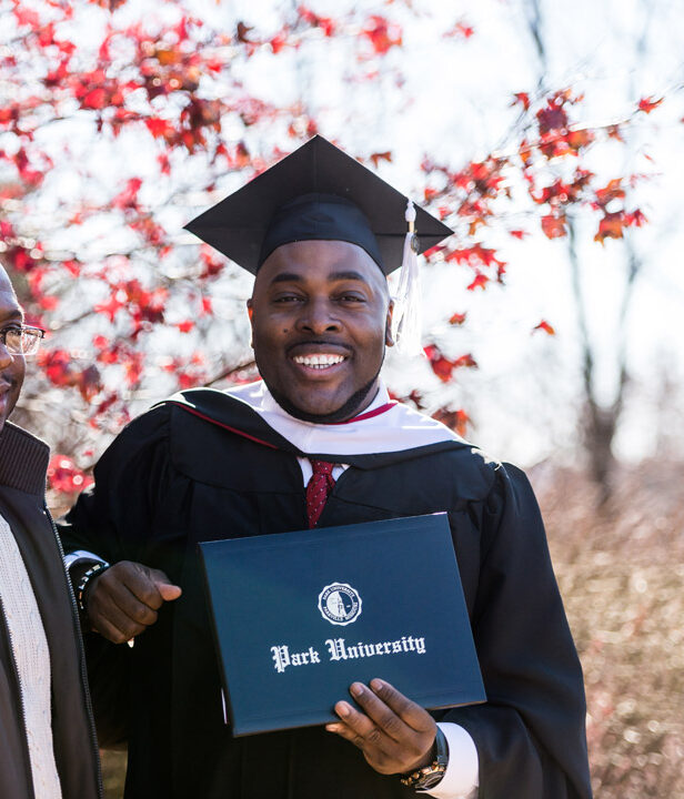 student holding diploma