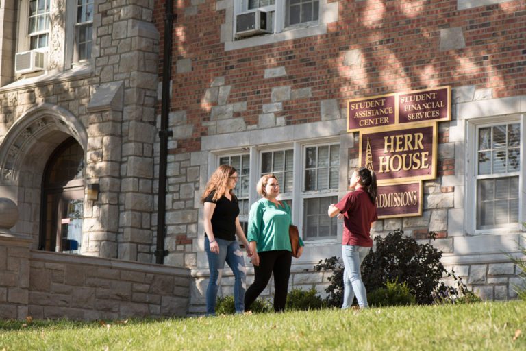 students in front of building