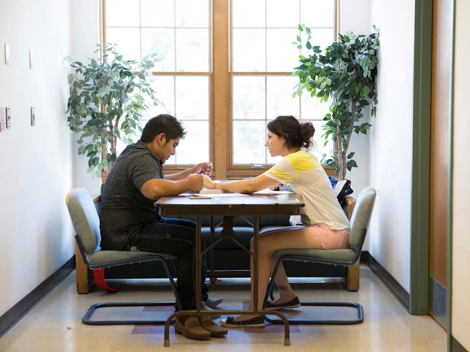 two people at a table,. accounting degree