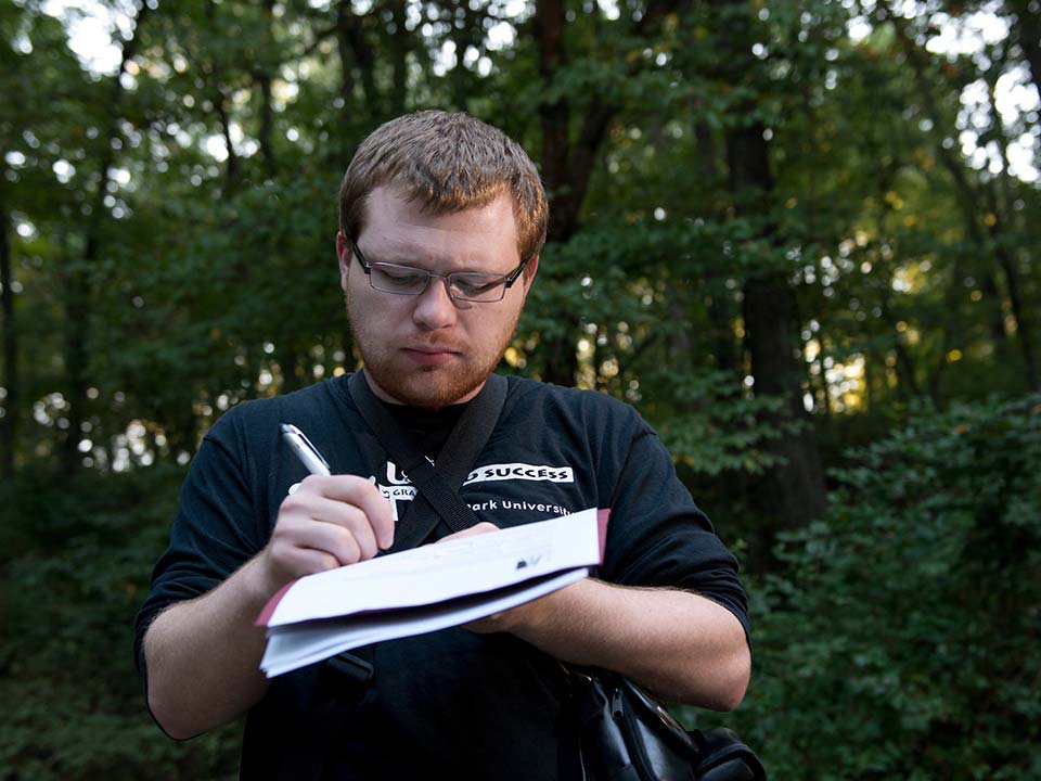 student writing in notebook