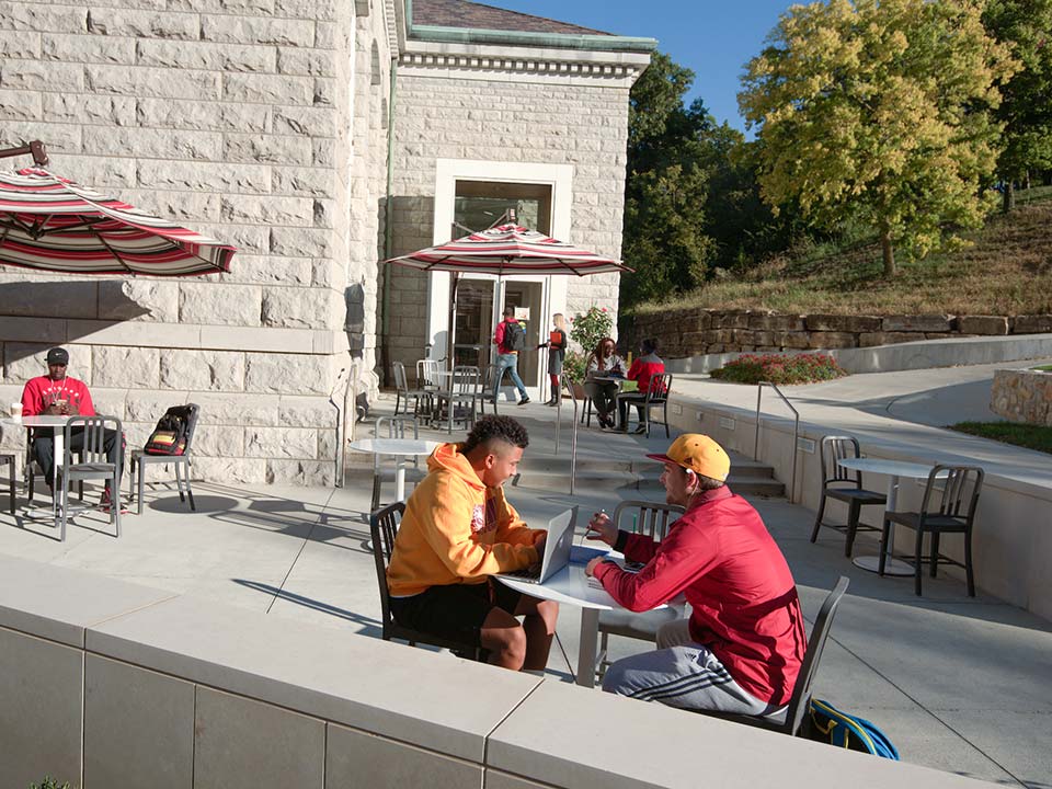 student at a table outside