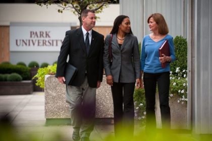 three students in front of Park sign