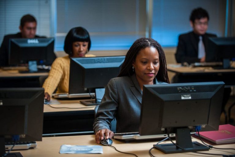 students at computers, business administration