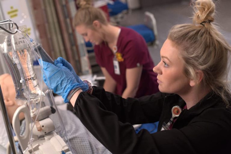 student with IV bag