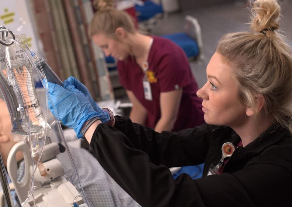 student with IV bag
