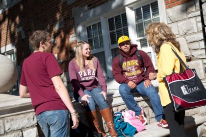 group of students outside in park shirts