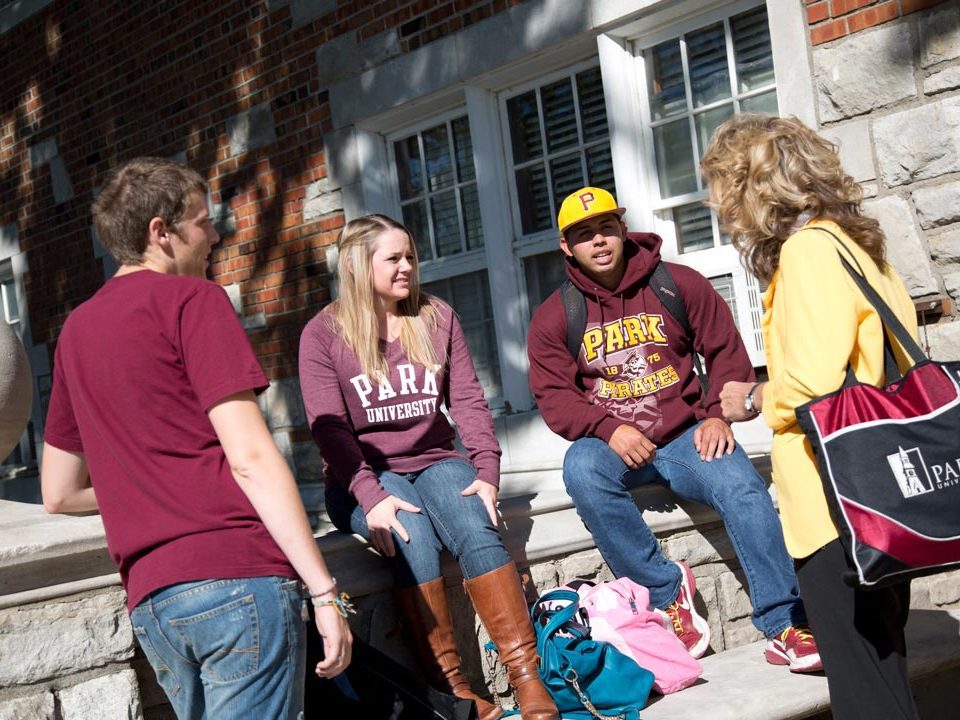 group of students outside in park shirts