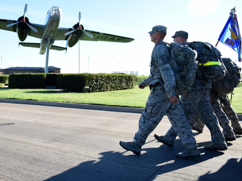 military members walking towards plane