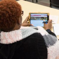 student on tablet looking at park site