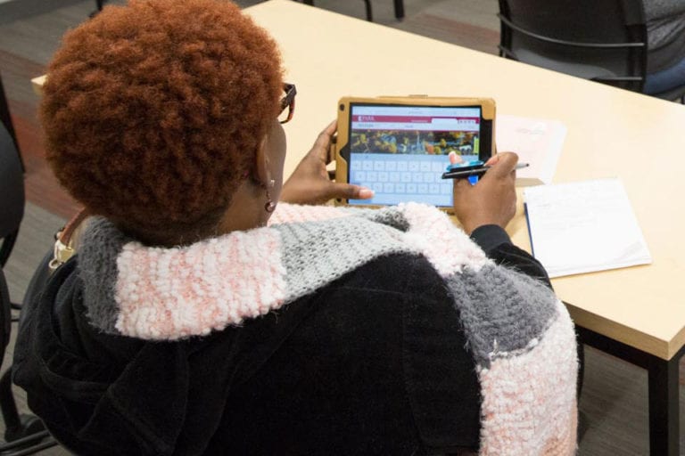 student on tablet looking at park site