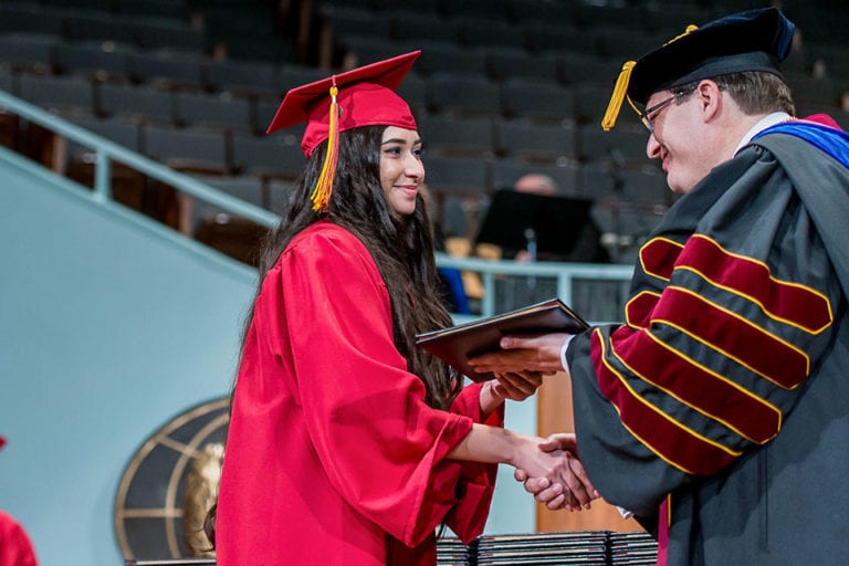 student getting diploma