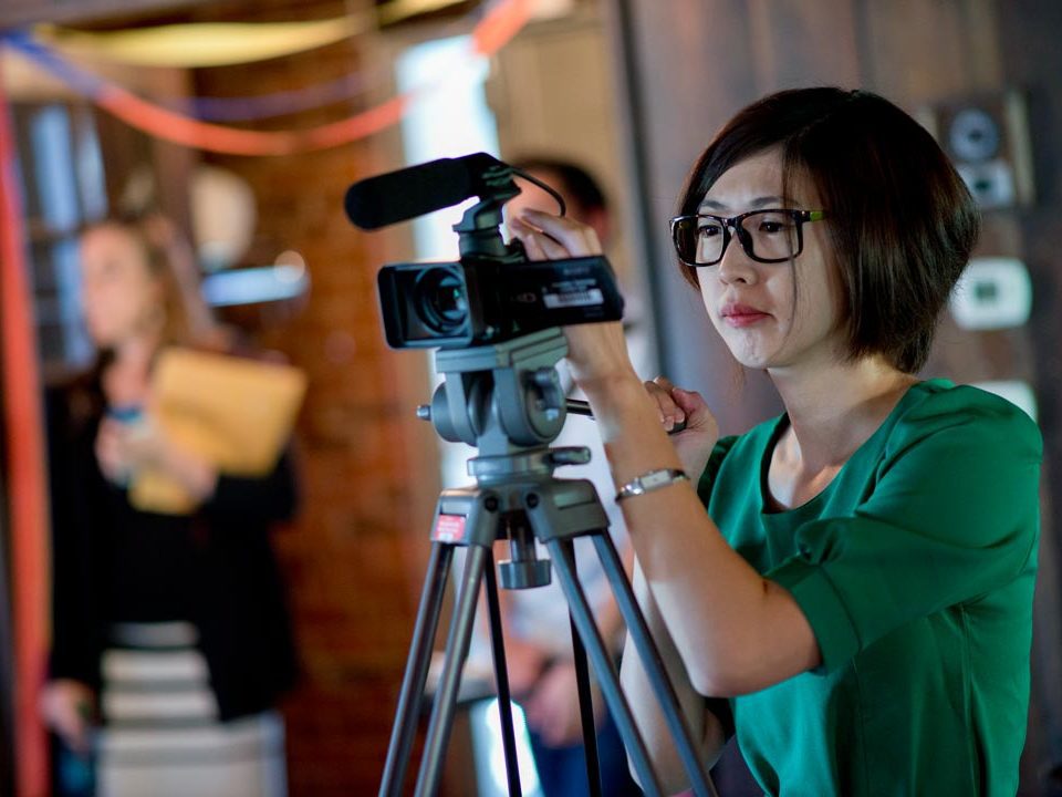 student with camera on tripod