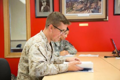 student at desk in military uniform