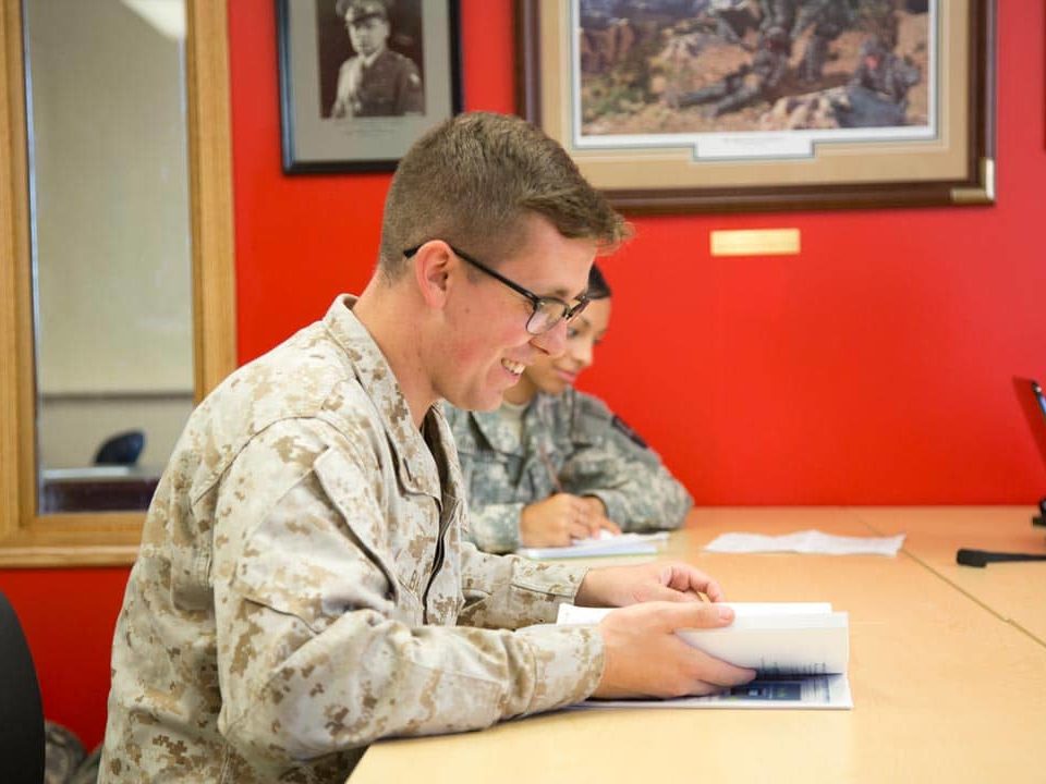 student at desk in military uniform