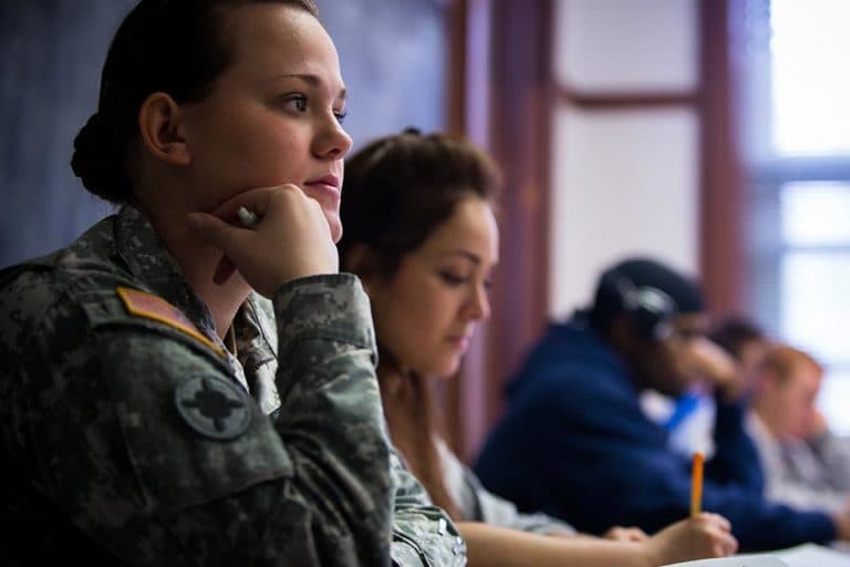 student in military uniform in class