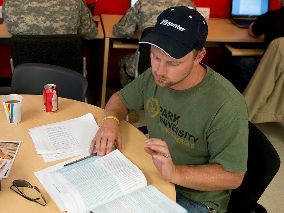 closeup of student at table with book