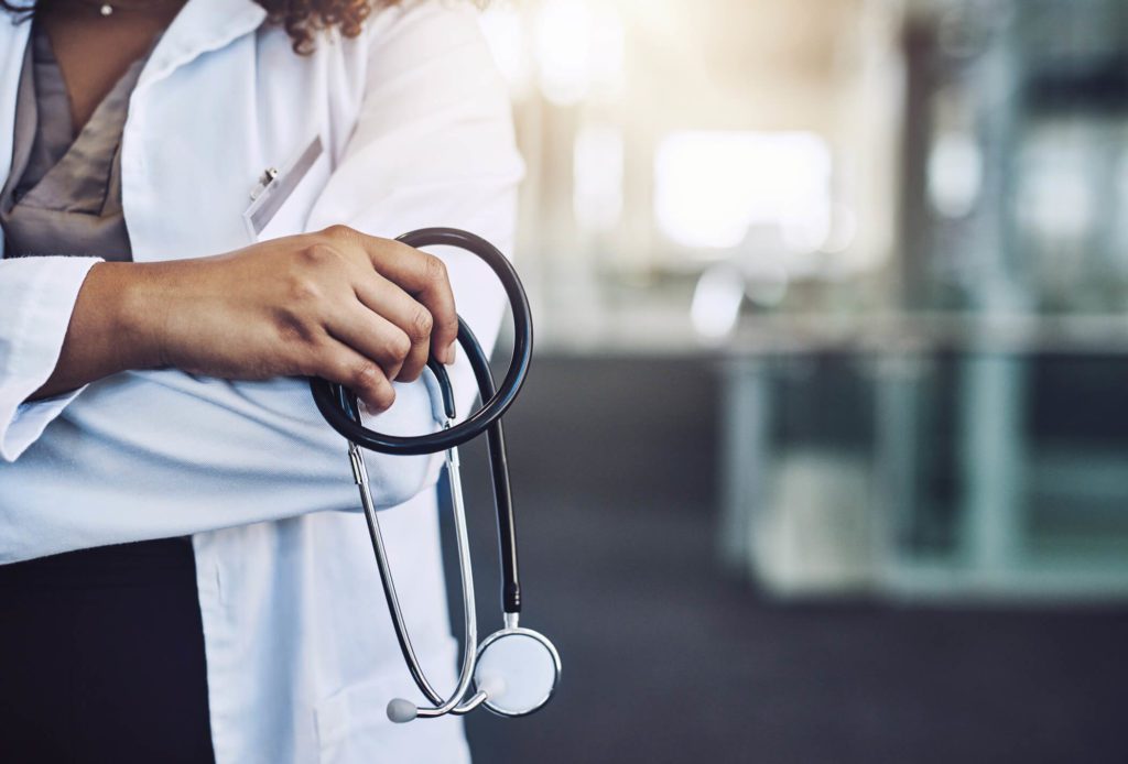 Healthcare professional posing with stethoscope