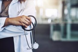 Healthcare professional posing with stethoscope
