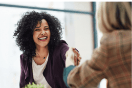 two women greeting each other