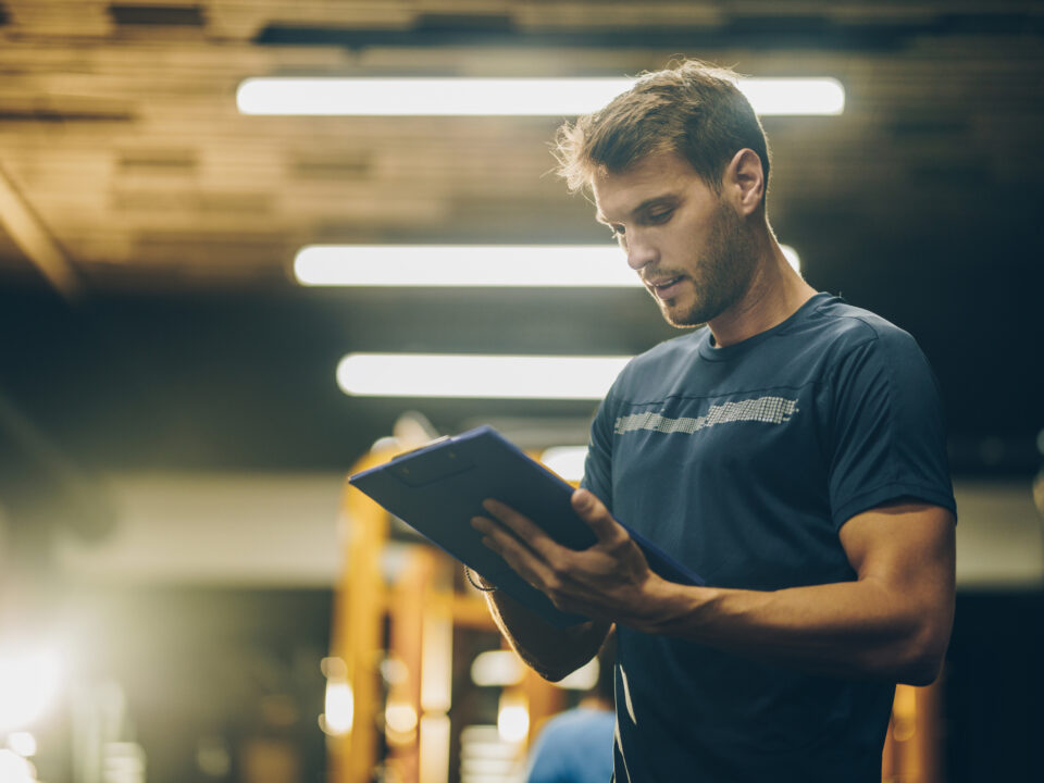 trainer reading manual in a gym