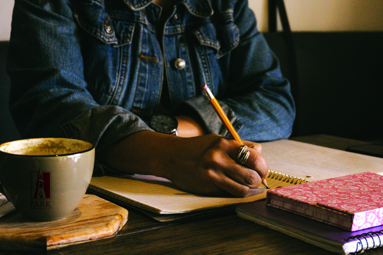 student writing at desk